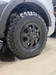 Satin black 16" Flarespace wheel with all-terrain tire installed on an AWD Ford Transit