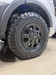 Satin black 16" Flarespace wheel with all-terrain tire installed on an AWD Ford Transit