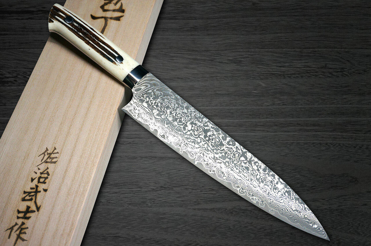 https://cdn11.bigcommerce.com/s-attnwxa/images/stencil/1280x1280/products/3708/171029/takeshi-saji-takeshi-saji-r2sg2-black-damascus-dhw-japanese-chefs-gyuto-knife-210mm-with-white-antler-handle__90145.1627544723.jpg?c=2