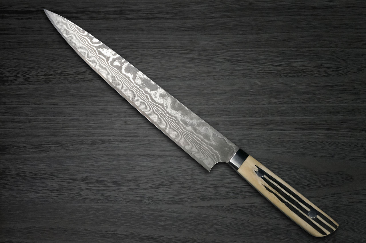 https://cdn11.bigcommerce.com/s-attnwxa/images/stencil/original/products/3533/193010/takeshi-saji-vg10-black-damascus-dhw-japanese-chefs-slicersujihiki-270mm-with-white-antler-handle__06967.1645616659.jpg?c=2&imbypass=on&imbypass=on