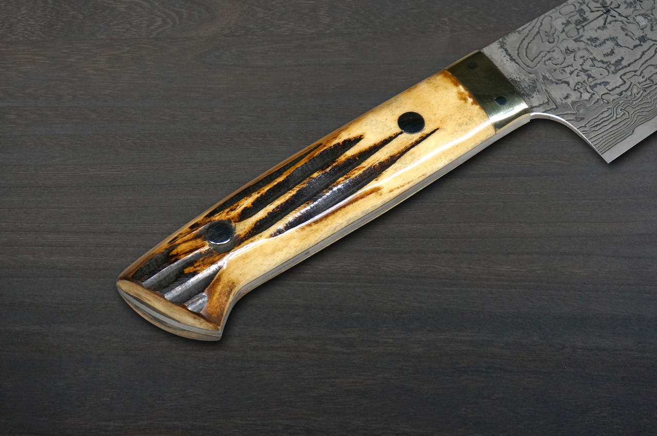 https://cdn11.bigcommerce.com/s-attnwxa/images/stencil/original/products/5605/218715/takeshi-saji-r2sg2-black-damascus-dhm-japanese-chefs-bunka-knife-180mm-with-brown-antler-handle__49668.1673128255.jpg?c=2&imbypass=on&imbypass=on