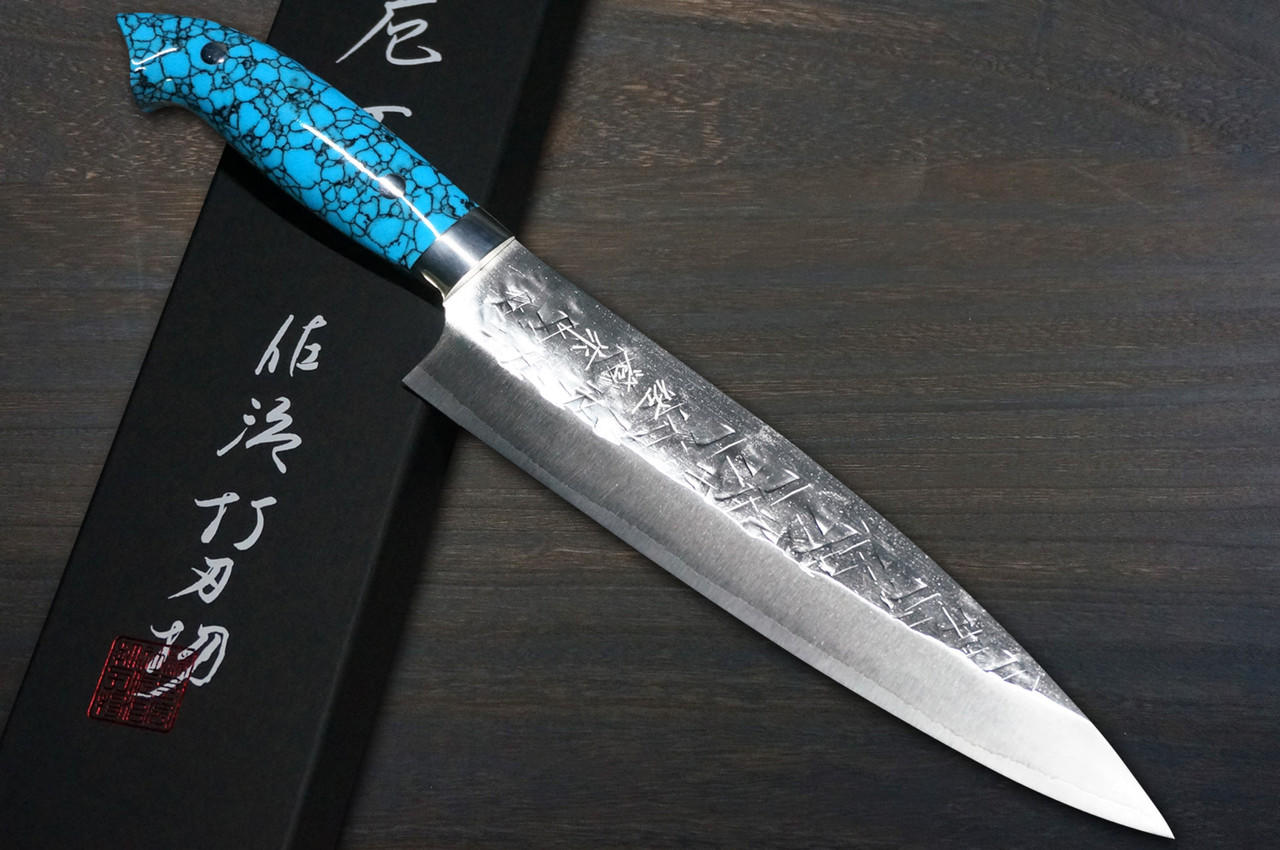 https://cdn11.bigcommerce.com/s-attnwxa/images/stencil/original/products/5896/229531/takeshi-saji-srs13-mirror-hammered-nnm-japanese-chefs-gyuto-knife-240mm-with-blue-turquoise-handle-nomura-special__23298.1690604374.jpg?c=2