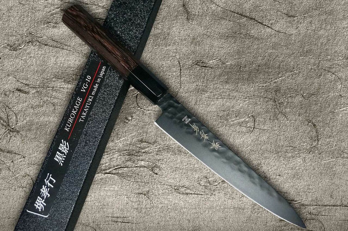 https://cdn11.bigcommerce.com/s-attnwxa/products/3635/images/173106/sakai-takayuki-sakai-takayuki-non-stick-coating-vg10-hammered-wa-kurokage-japanese-chefs-petty-knifeutility-150mm-with-wenge-handle__97341.1627548056.720.450.jpg?c=2