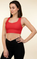 Left front view of the Anuri EcoForm Recycled Longline Sports Bra in Poppy Red, featuring a modern scoop neckline and a supportive, structured crop silhouette.