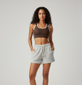 Front view of a model wearing the Anuri Powerform Padded Sports Bra in hot chocolate with white contrast trim.