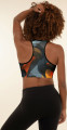 Rear view of model wearing the Anuri Ignite Ember Abstract Padded Sports Bra featuring a black and fiery orange abstract print with racerback design and supportive athletic fit.