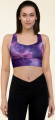 Front view of a model wearing the Anuri Flow Recycled Longline Sports Bra in a cosmic purple abstract print, highlighting the scoop neckline and structured crop silhouette.
