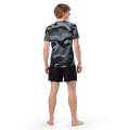 Male model showcasing the back view of the Anuri Shadow Form Tactical Men’s Recycled Rash Guard in grey camouflage.