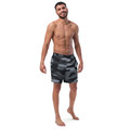 Front view of an athletic male model wearing the Anuri Ignite Men's Recycled Swim Trunks in a premium black camouflage pattern.