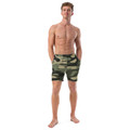 Front view of an athletic male model wearing the Anuri Flow Men's Recycled Swim Trunks in a premium green and black camouflage pattern.