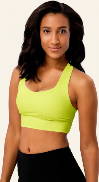 Left front view of the Anuri EcoForm Recycled Longline Sports Bra in Primrose Pink, featuring a modern scoop neckline and a supportive, structured crop silhouette.
