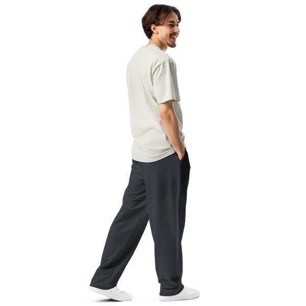 Male model wearing Anuri Shadow Form Men’s Wide-Leg Recycled Joggers in dark stealth grey.