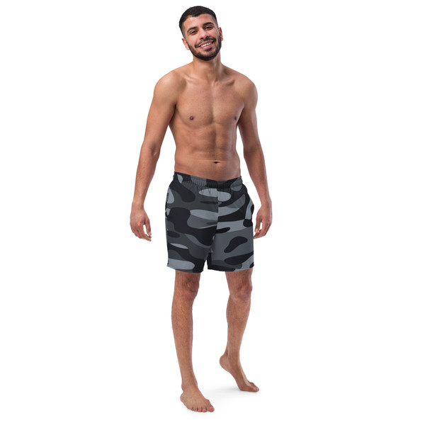 Front view of an athletic male model wearing Men's Recycled Swim Trunks in a premium black camouflage pattern.