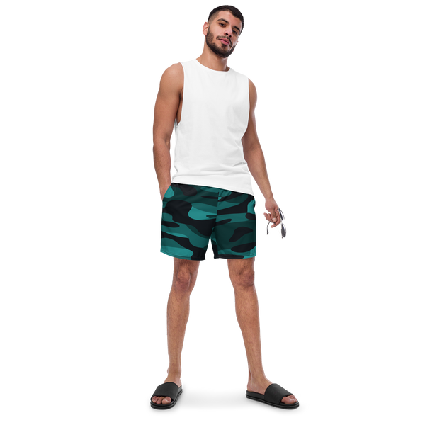 Front view of an athletic male model wearing the Anuri Ignite Men's Recycled Swim Trunks in a premium teal and black camouflage pattern.