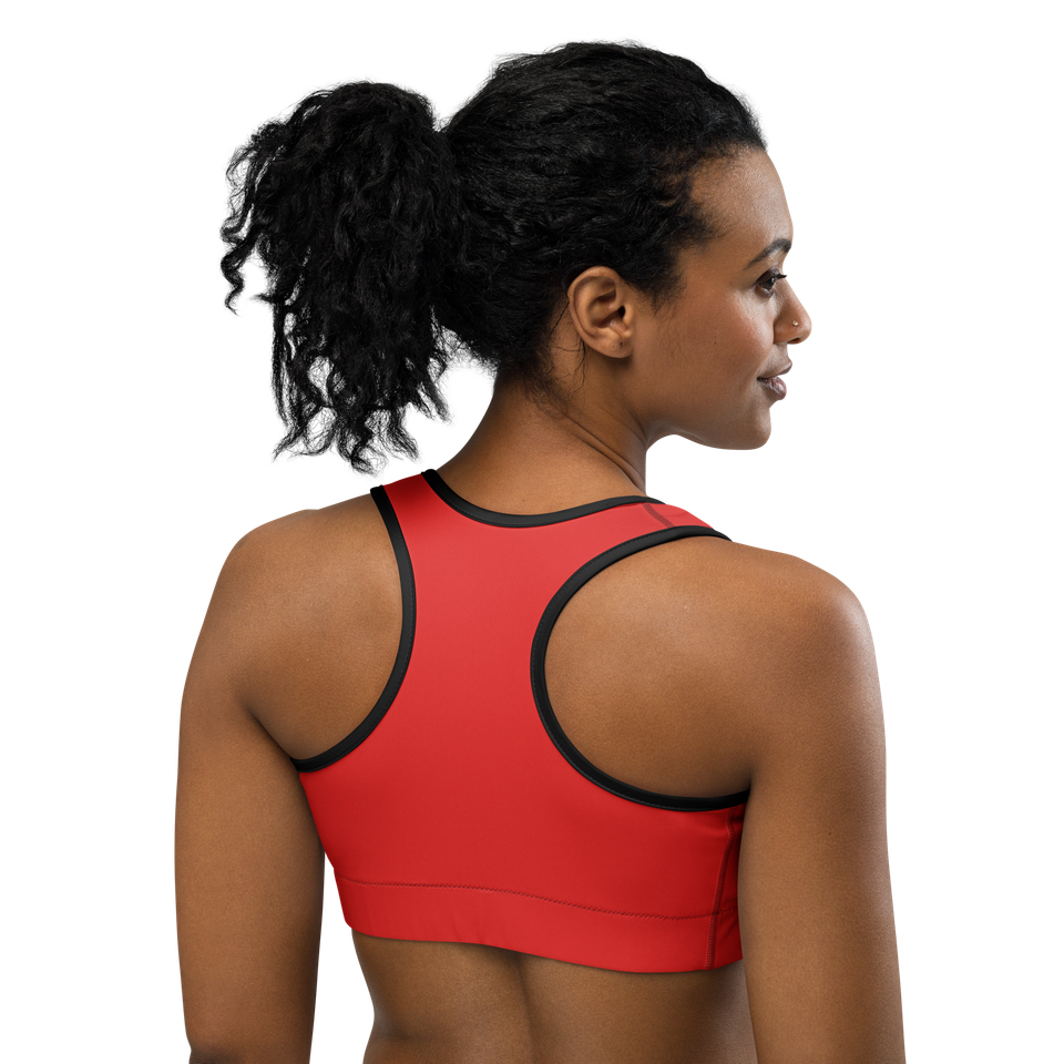 Back view of the Anuri Kinetic Racerback Sports Bra in Poppy Red, showcasing the supportive racerback cut and black flatlock stitching details.