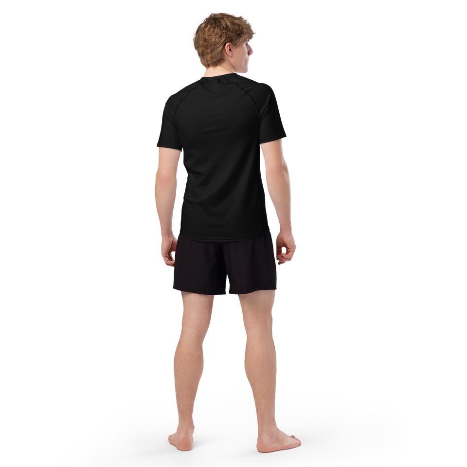 Model wearing black eco-performance rash guard – sleek, fitted, moisture-wicking recycled athletic shirt by Anuri.