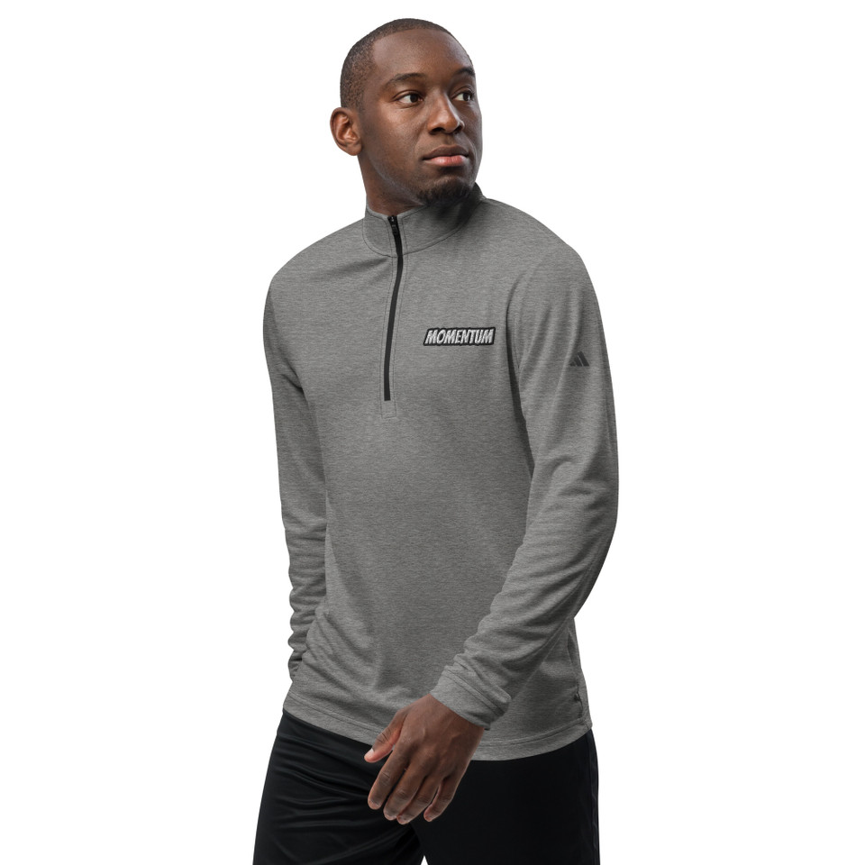 Model wearing black heather Adidas quarter zip pullover with “Momentum” logo – soft, sustainable training top by Anuri Activewear.