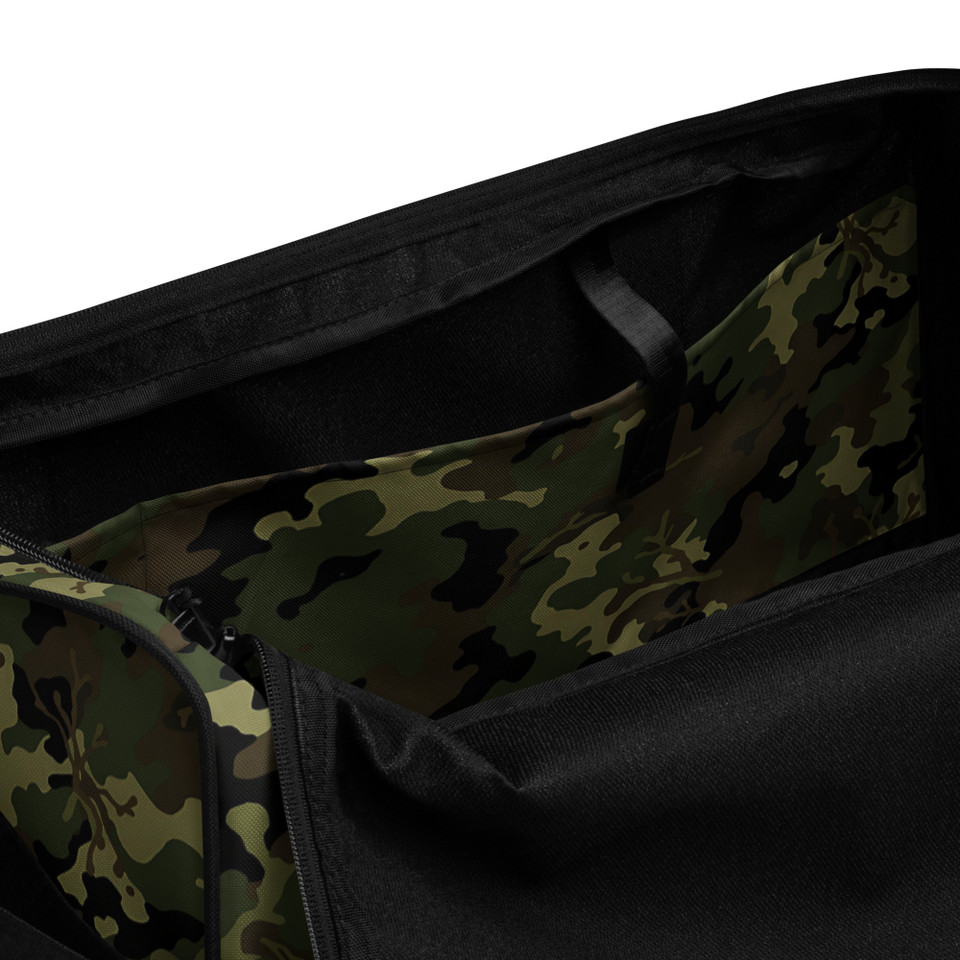 a spacious duffle bag featuring a classic green, brown, and black military camouflage pattern. It has black padded handles and a black adjustable shoulder strap.