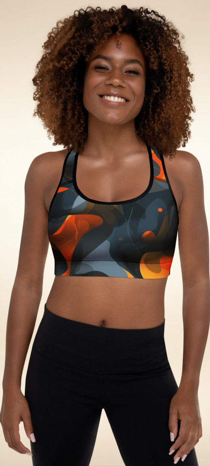 Front view of model wearing the Anuri Ignite Ember Abstract Padded Sports Bra with a dark abstract print, scoop neckline, and orange ember-inspired detailing.