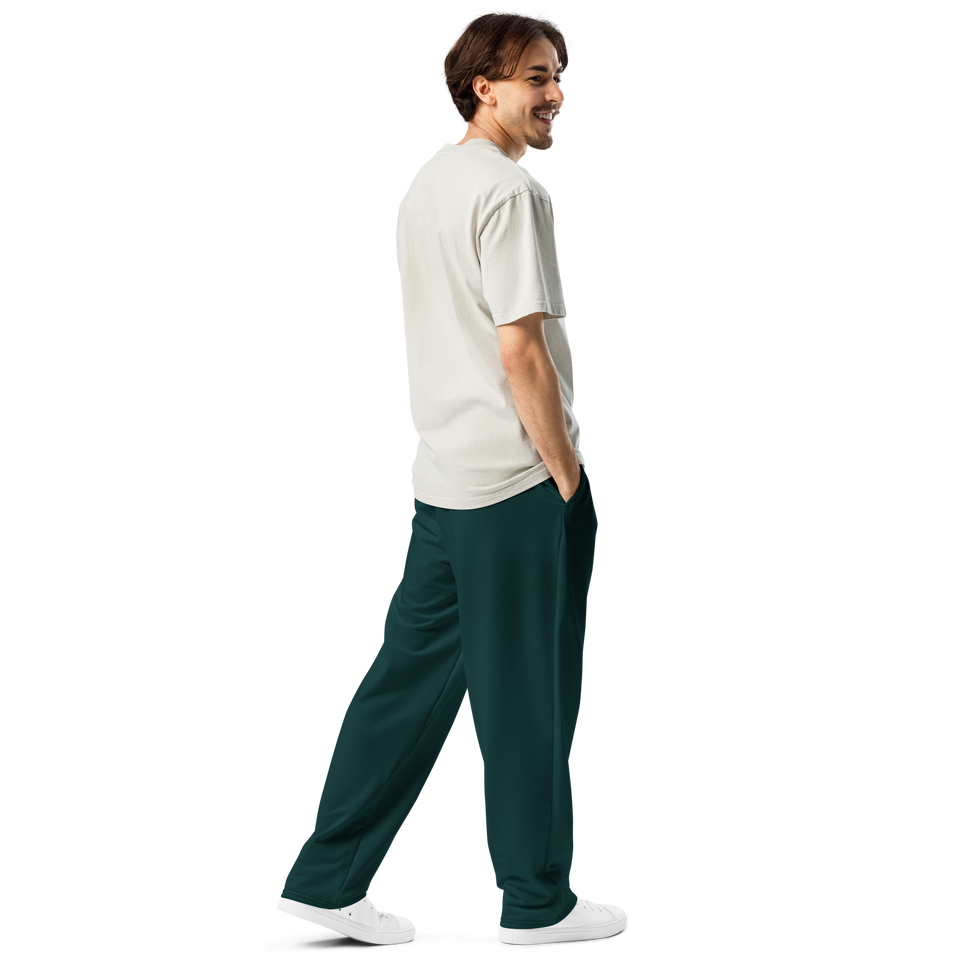 Male model wearing Anuri Ignite Power Men’s Wide-Leg Recycled Joggers in bold teal green.