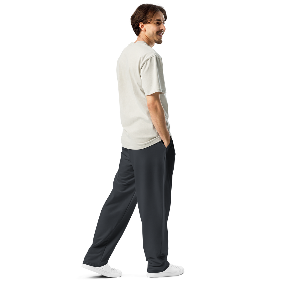 Male model wearing Anuri Shadow Form Men’s Wide-Leg Recycled Joggers in dark stealth grey.