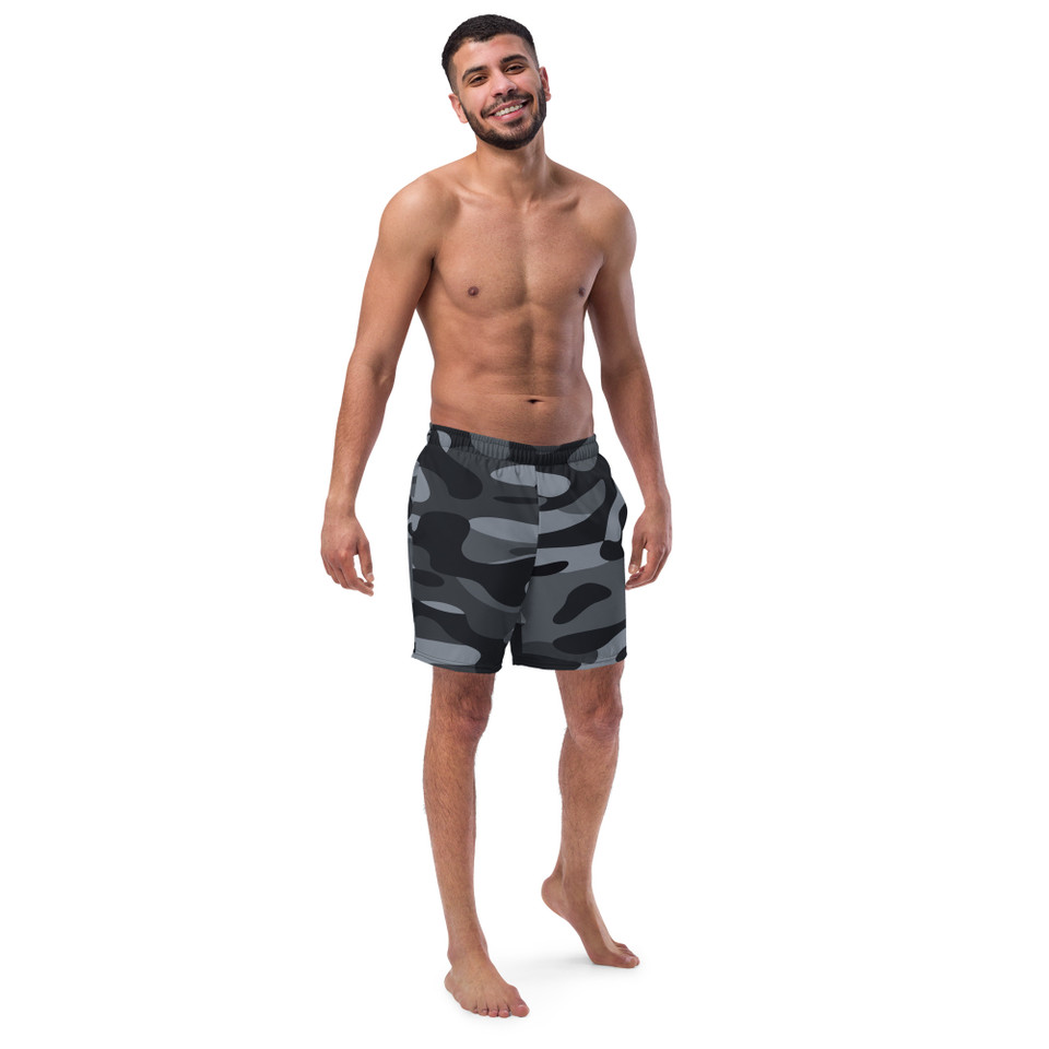 Front view of an athletic male model wearing Men's Recycled Swim Trunks in a premium black camouflage pattern.