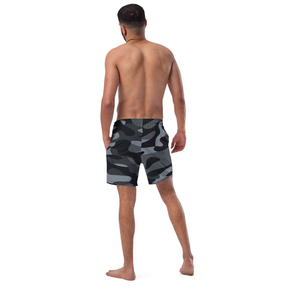 Back view of an athletic male model highlighting the tailored fit and elastic waistband of the Anuri ShadowForm Men's Recycled Swim Trunks in camo.