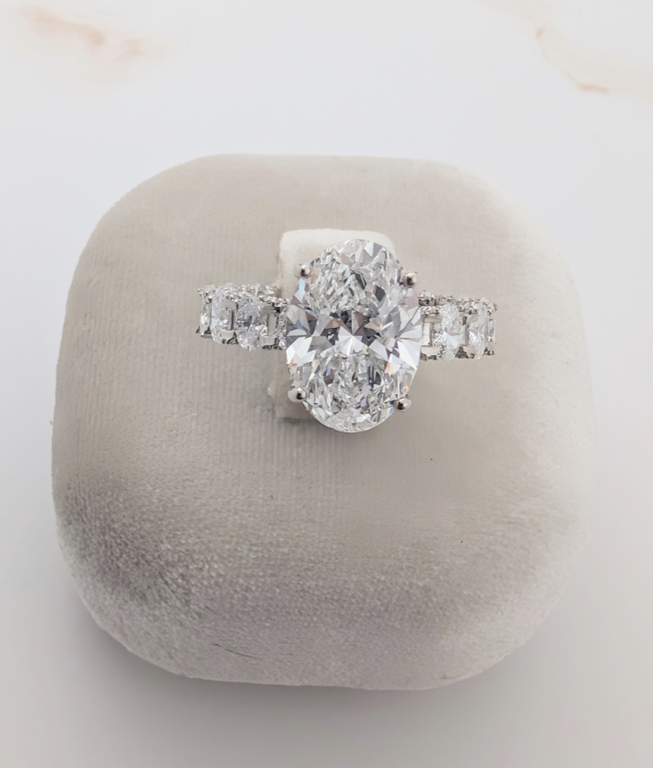 Oval diamond engagement ring with graduated side stones