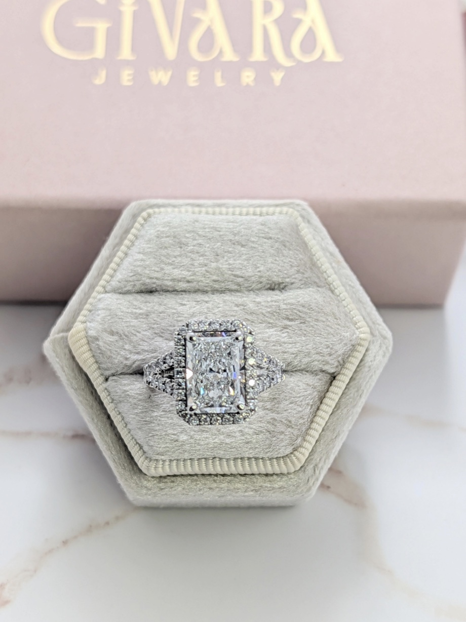 Radiant diamond halo ring in a velvet box