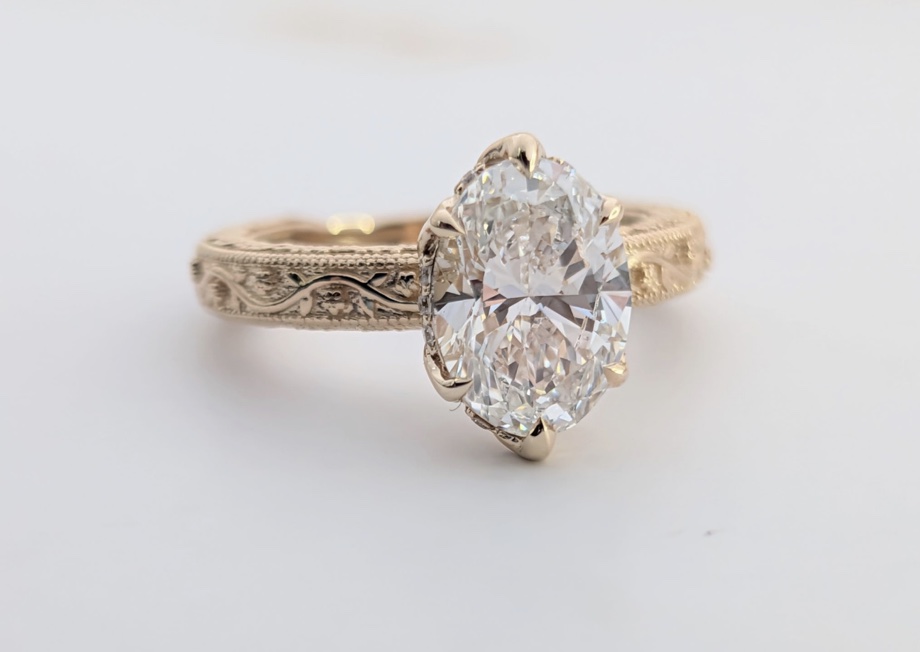 Oval diamond ring with engraved yellow-gold band