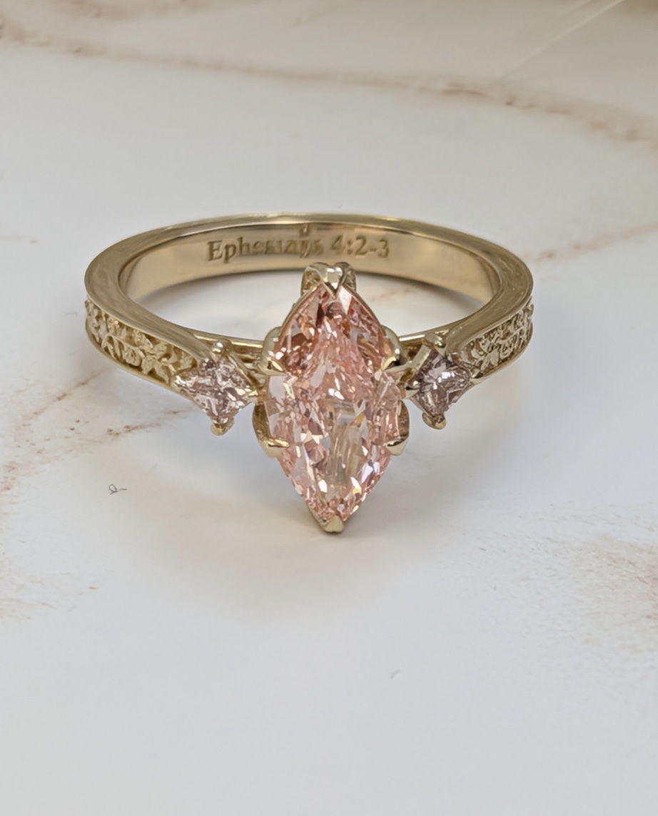 Pink marquise diamond ring with engraved band
