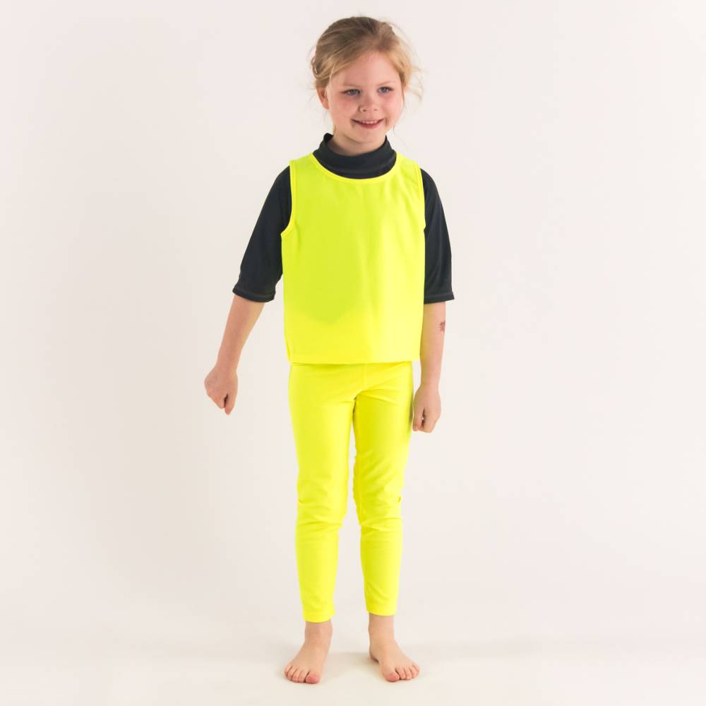 Girl standing in Neon Yellow Swim leggings with Neon Yellow Be Seen Over Vest - front shot