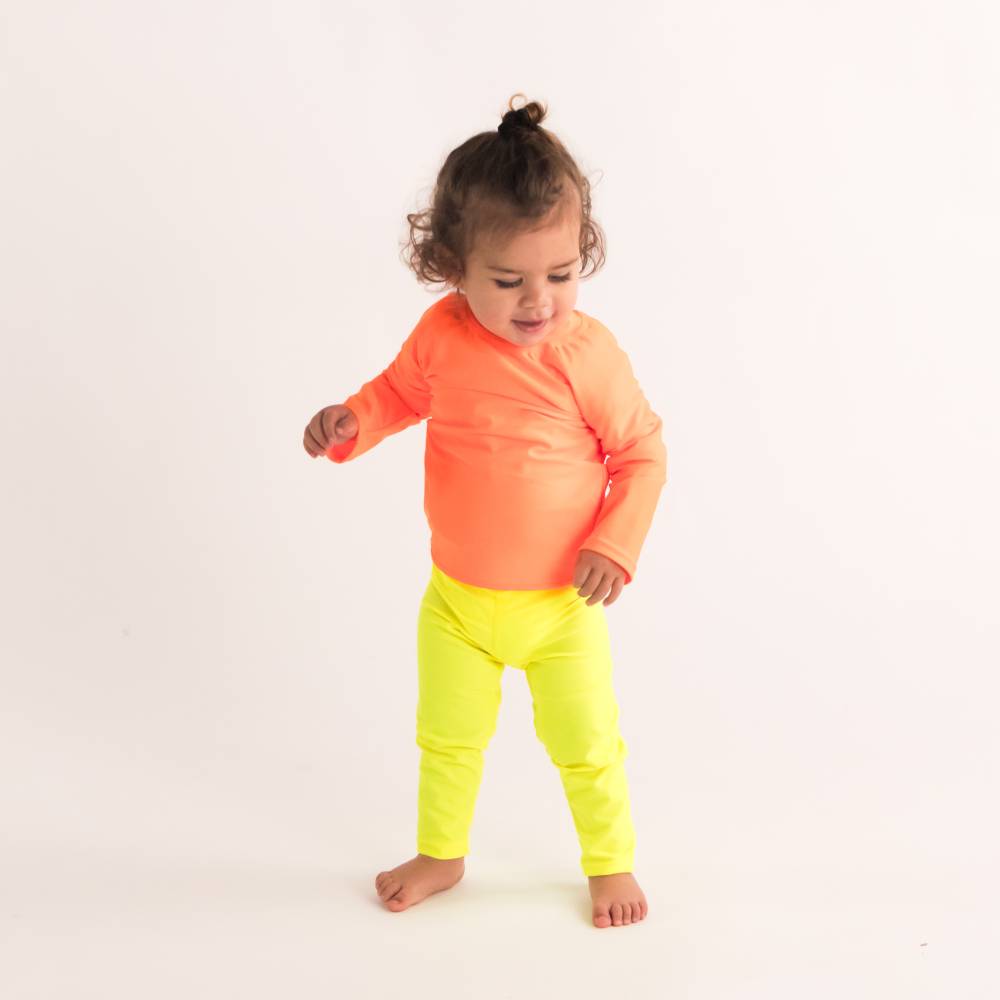 Toddler standing in Neon Yellow Swim leggings with Neon Orange Swim Rash Vest