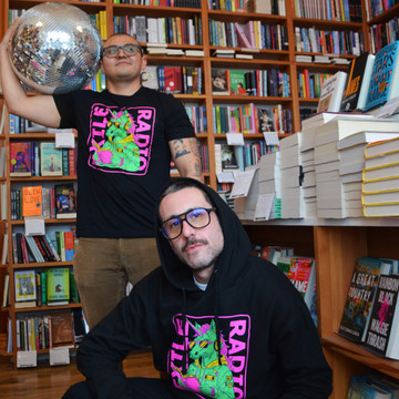 Gus Moreno, author of This Thing Between Us, and Zachary Pace, author of I Sing to Use the Waiting, modeling Exile Radio shirts/hoodies, April 2024.