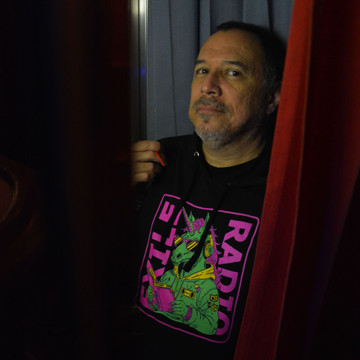 Javier Ramirez, of Exile in Bookville, modeling an Exile Radio hoodie, April 2024.