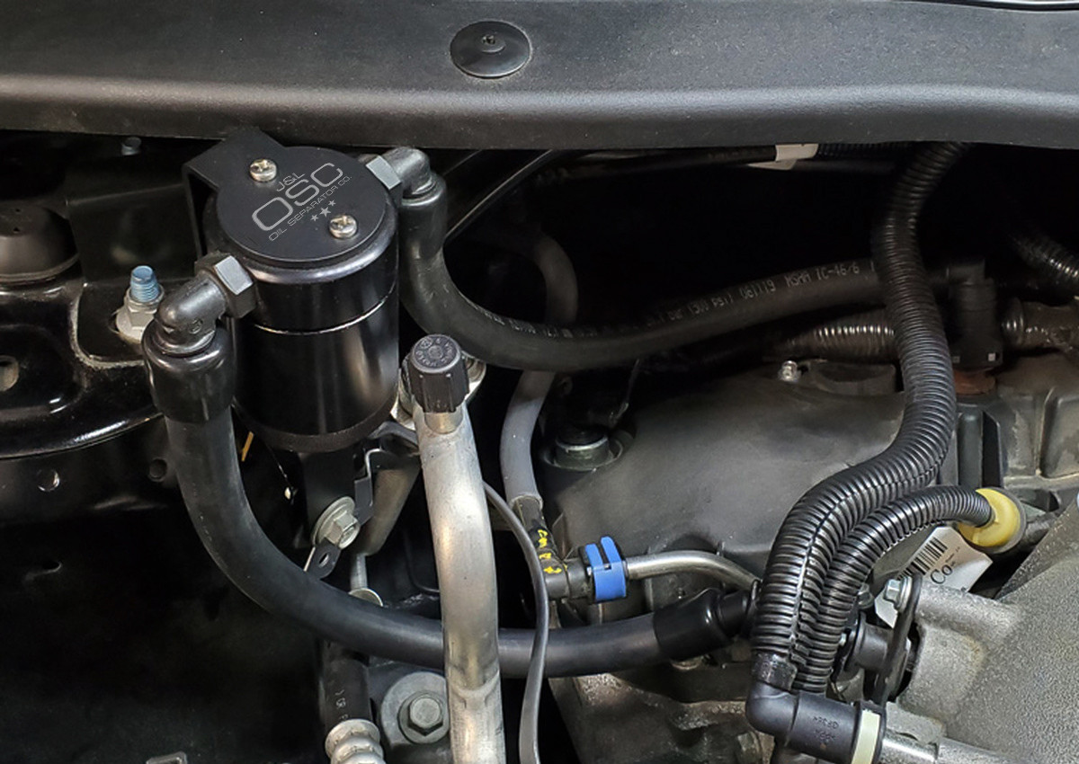 J&L Oil Separator 3.0 Passenger Side (2013-2019 Ford Explorer Sport 3.5L EcoBoost V6) unit mounted in vehicle engine compartment.