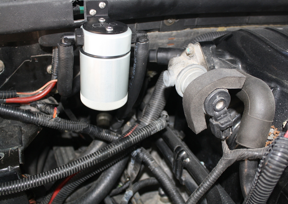 Close-up view of J&L Oil Separator 3.0 Passenger Side (1999-2004 Ford F-150 Lightning; 2002-2003 F-150 Harley Davidson) unit in engine compartment.