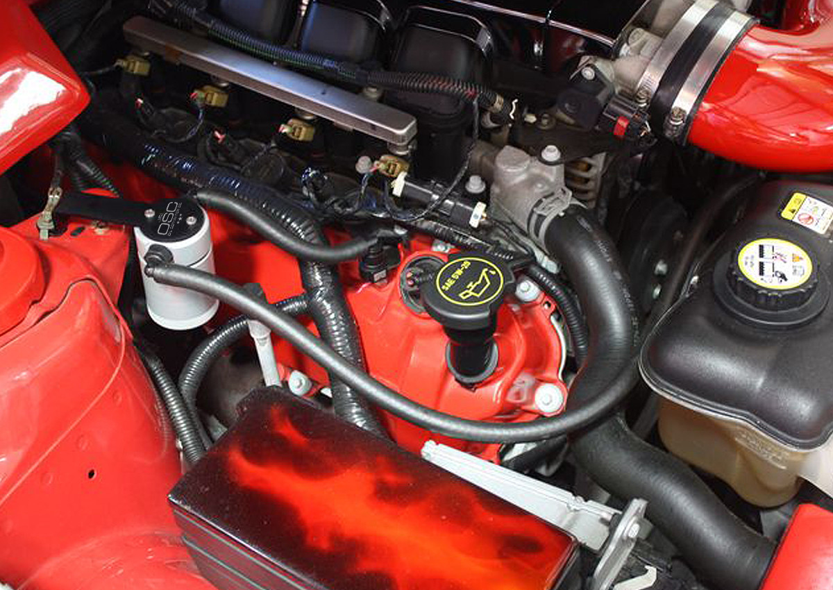 J&L Oil Separator 3.0 Passenger Side (2005-2010 Mustang GT; Bullitt; Saleen) installed  unit in a red engine bay.