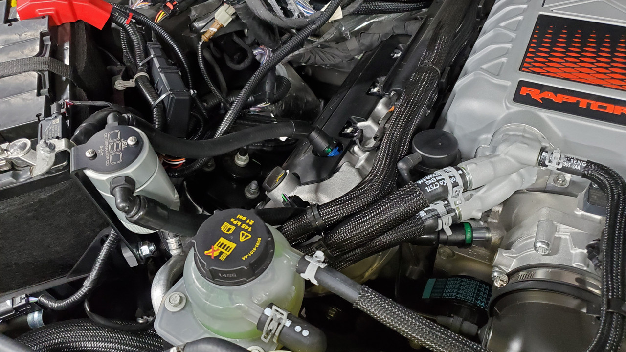 J&L Oil Separator 3.0 Passenger Side (2023-2025 Ford F150 Raptor R) kit fully installed in truck engine bay.
