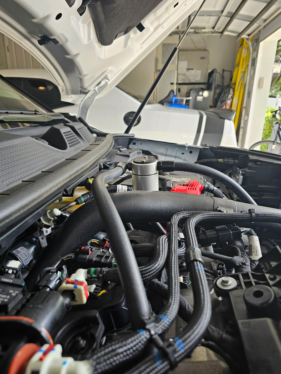 J&L Oil Separator 3.0 (2025 Ford Bronco Sport, Maverick; 2023-2025 Ford Escape; Lincoln Corsair 2.0L)  kit fully installed in vehicle engine bay.