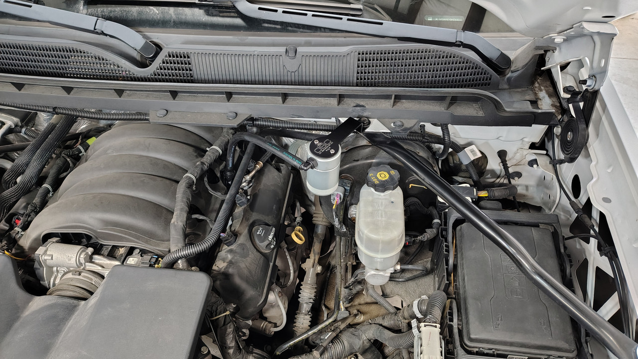J&L Oil Separator 3.0 PCV Side (2014-2018 Chevy Silverado/GMC Sierra 1500 4.3L) kit fully installed in truck engine bay.
