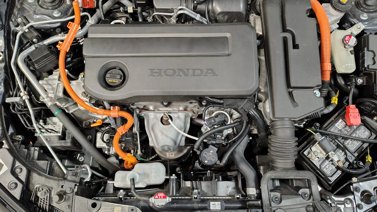 J&L 3.0 PCV side oil separator fully installed in a 2023-2026 Honda Accord or CR-V Hybrid engine bay.