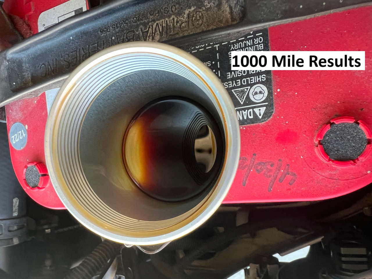 Close-up view of J&L Oil Separator 3.0 PCV Side hose connection under the hood