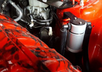 Close-up view of J&L Oil Separator 3.0 Driver Side (2015-2023 Ford Mustang EcoBoost) unit in engine bay.