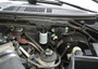 J&L Oil Separator 3.0 Driver Side (1999-2004 Ford F-150 Lightning; 2002-2003 F-150 Harley Davidson) unit mounted in truck engine compartment.