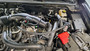 J&L Oil Separator 3.0 PCV Side (2024-2025 Ford Ranger Raptor 3.0L)  kit fully installed in truck engine bay.