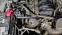 Detail view of a J&L oil separator unit mounted inside a truck engine bay.