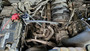 Close-up view of a J&L oil separator unit installed inside a truck engine compartment.