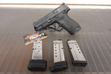 S&W M&P 40 Shield pistol, Smith and Wesson Shield 40, M&P Shield side view, Shield 40 with magazines, compact 40 caliber handgun, S&W pistol