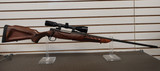 MOSSBERG 4 X 4 7MM REM MAG RIFLE W/SIMMONS SCOPE, Mossberg 4x4 rifle with Simmons scope, 7mm Rem Mag hunting rifle side view, bolt action scoped rifle close up, Mossberg hunting firearm detail, long range deer rifle, magnum bolt gun